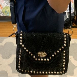 Black Crossbody Bag with gold accents.